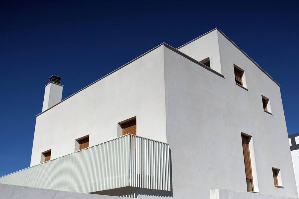 White stucco chimney on a modern flat-roofed building. Chimney & Fireplace Care · Pompano Beach, Florida