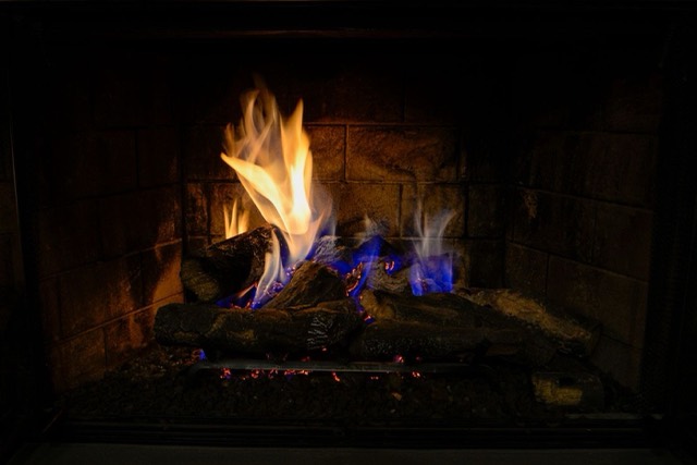Gas fireplace burning with a steady flame — Chimney Cap Installation in Pompano Beach, FL